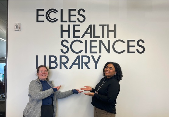 students i front of Ecles Health Sciences library sign